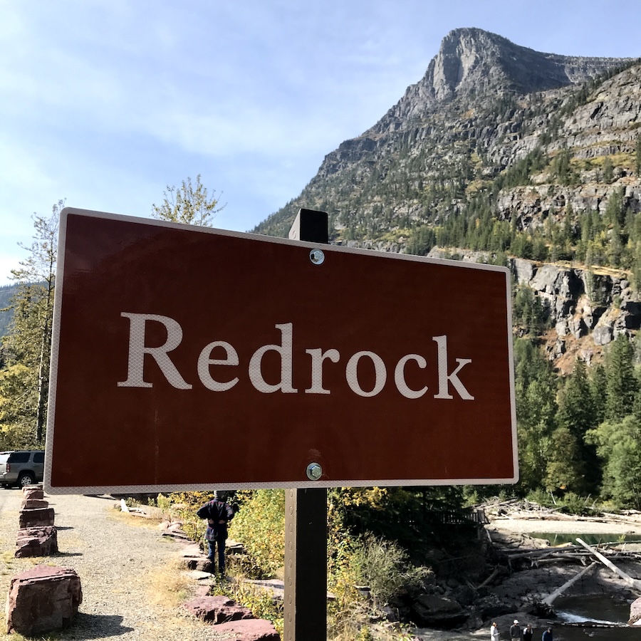 redrock sign next to mountain