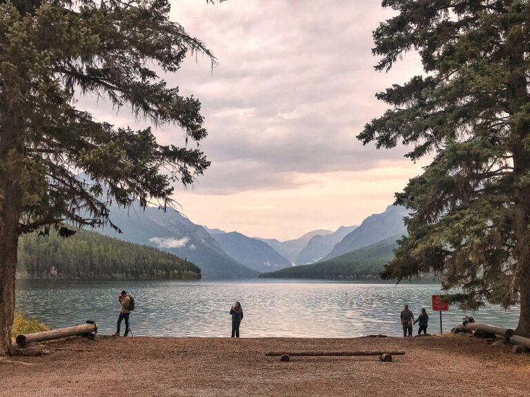 Several visitors enjoy the sunset view of Bowman Lake