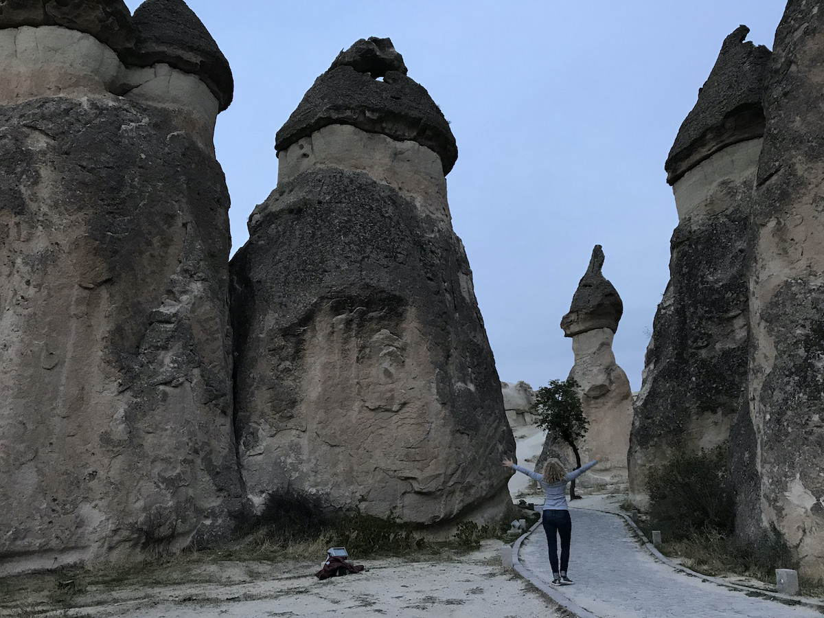 woman in front of the fairy chimneys in pasabag a valley in Cappadocia Turkey