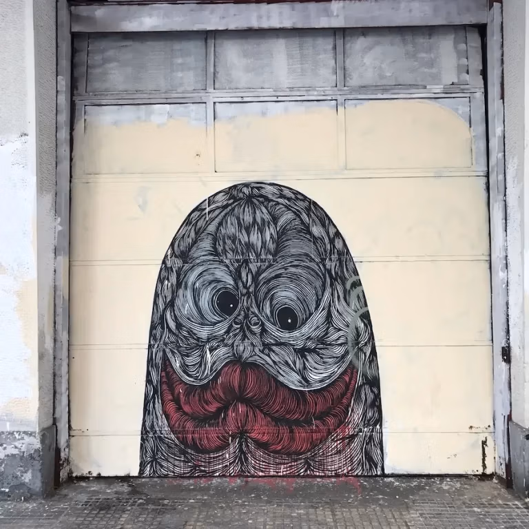 Athen street art of a finger with a face