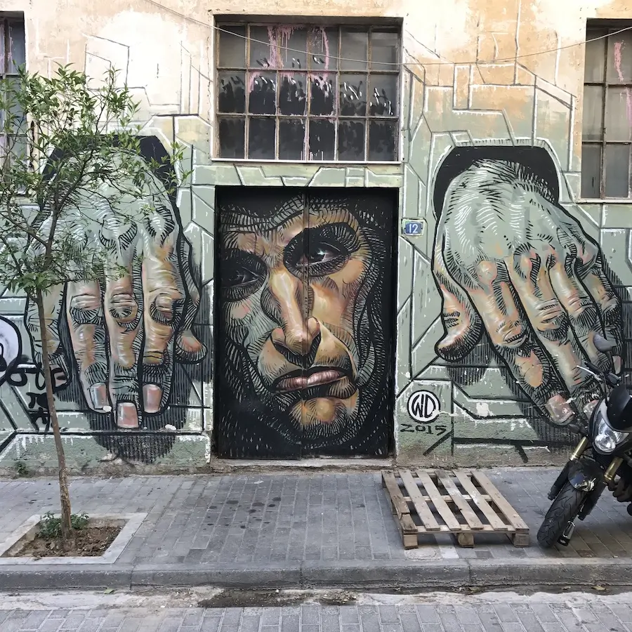 A mural of a man with his hands locked up by WD in Athens