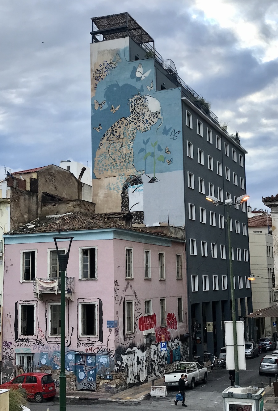 Street scene with graffiti on the side of tall building