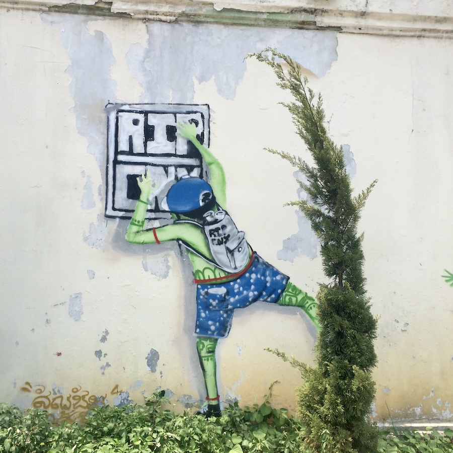 street art man hanging sign
