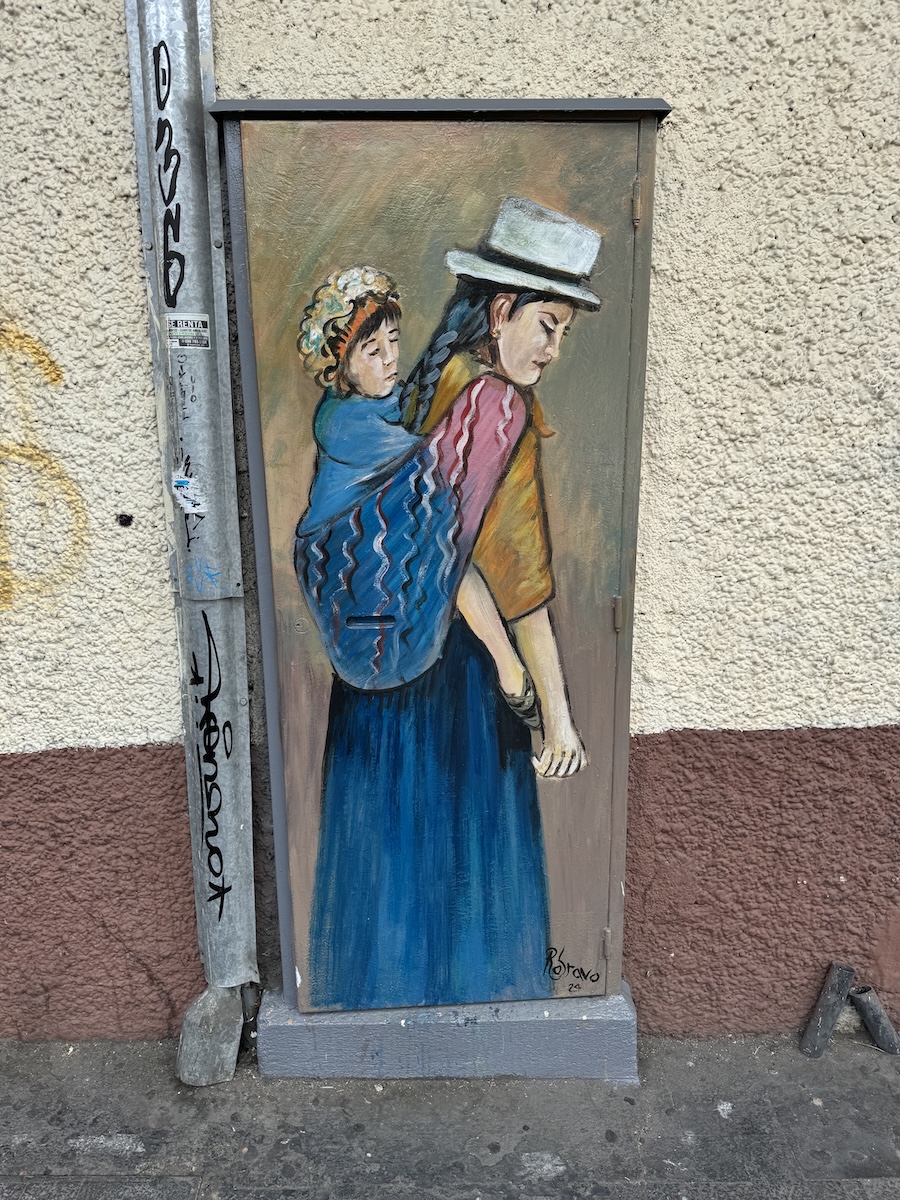 Hand-painted portrait of a local Cuenca character on a metal utility box by Roberto Bravo in Cuenca, Ecuador