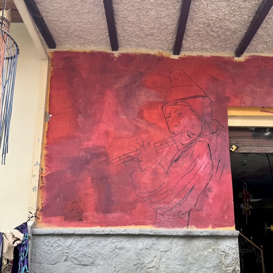 Wall drawing of person playing a flute