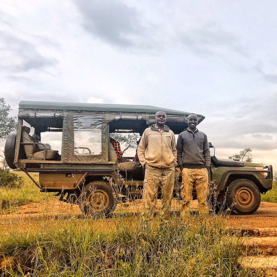two men in front of safari vehicle