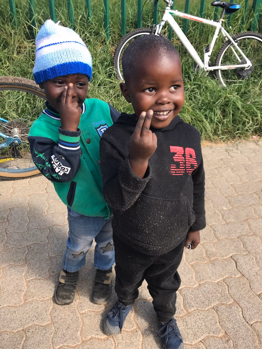 two little boys pose with two fingers