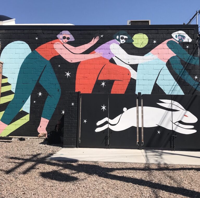 Colorful mural of three women and a bunny by Poni at Crush Walls in Denver