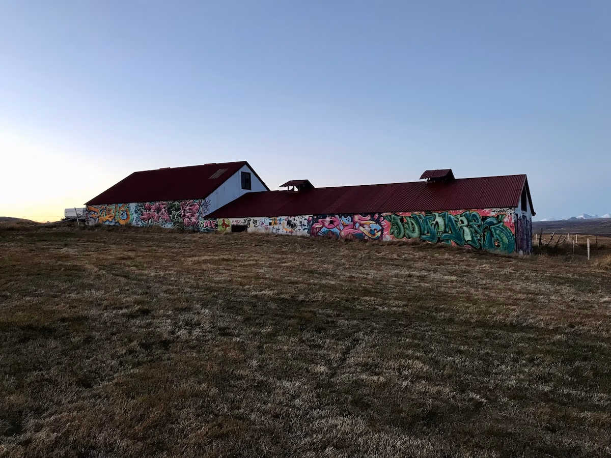 graffiti covered barn on a hill