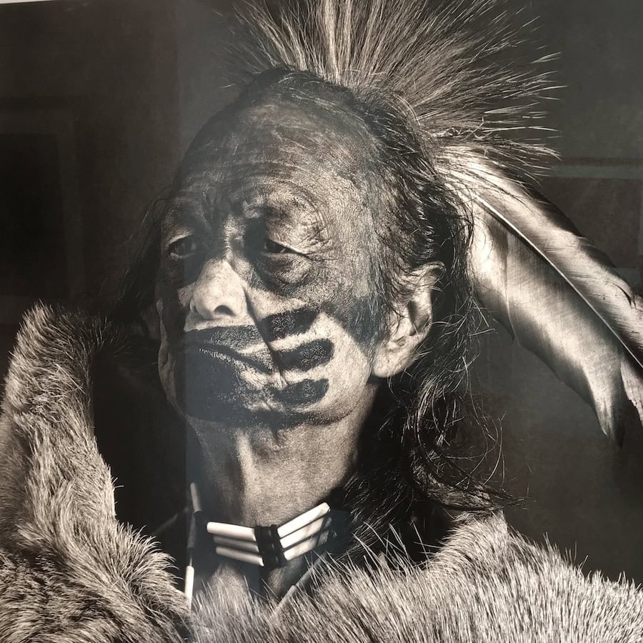 photo of an indian warrior with feathers