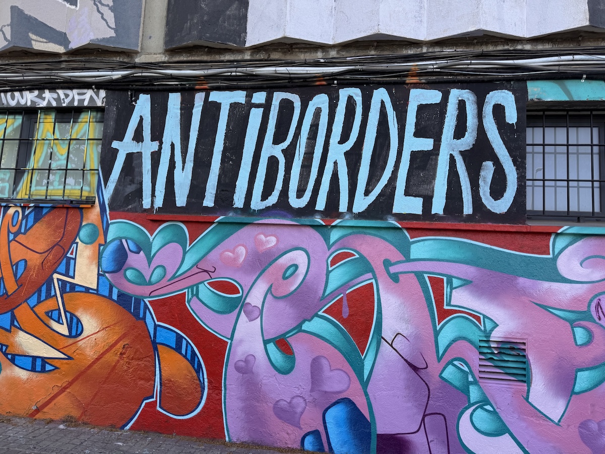 'Antiborders' street art on Barcelona promenade