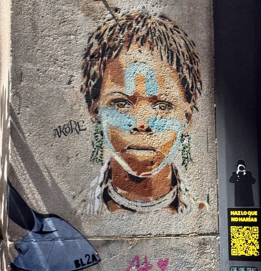 African child with face paint street art in Barcelona