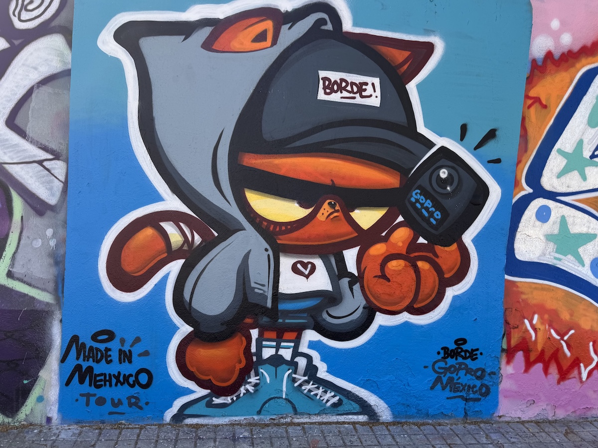 Cat with hoodie street art on Barcelona promenade