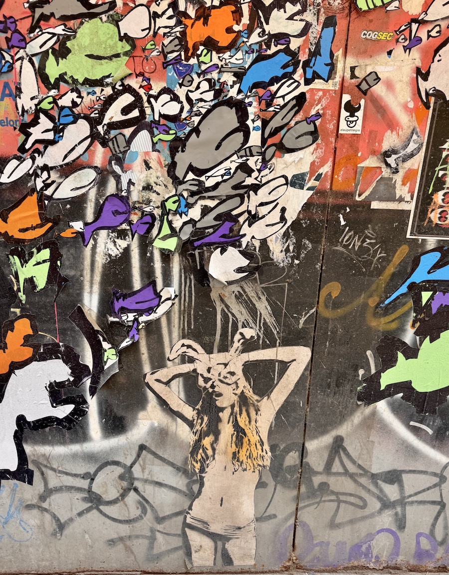 Colorful abstract with girl covering her eyes in foreground graffiti in Barcelona