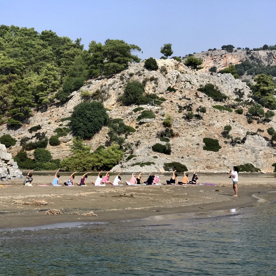 A group of women doing yogo on the shore in Dalyan