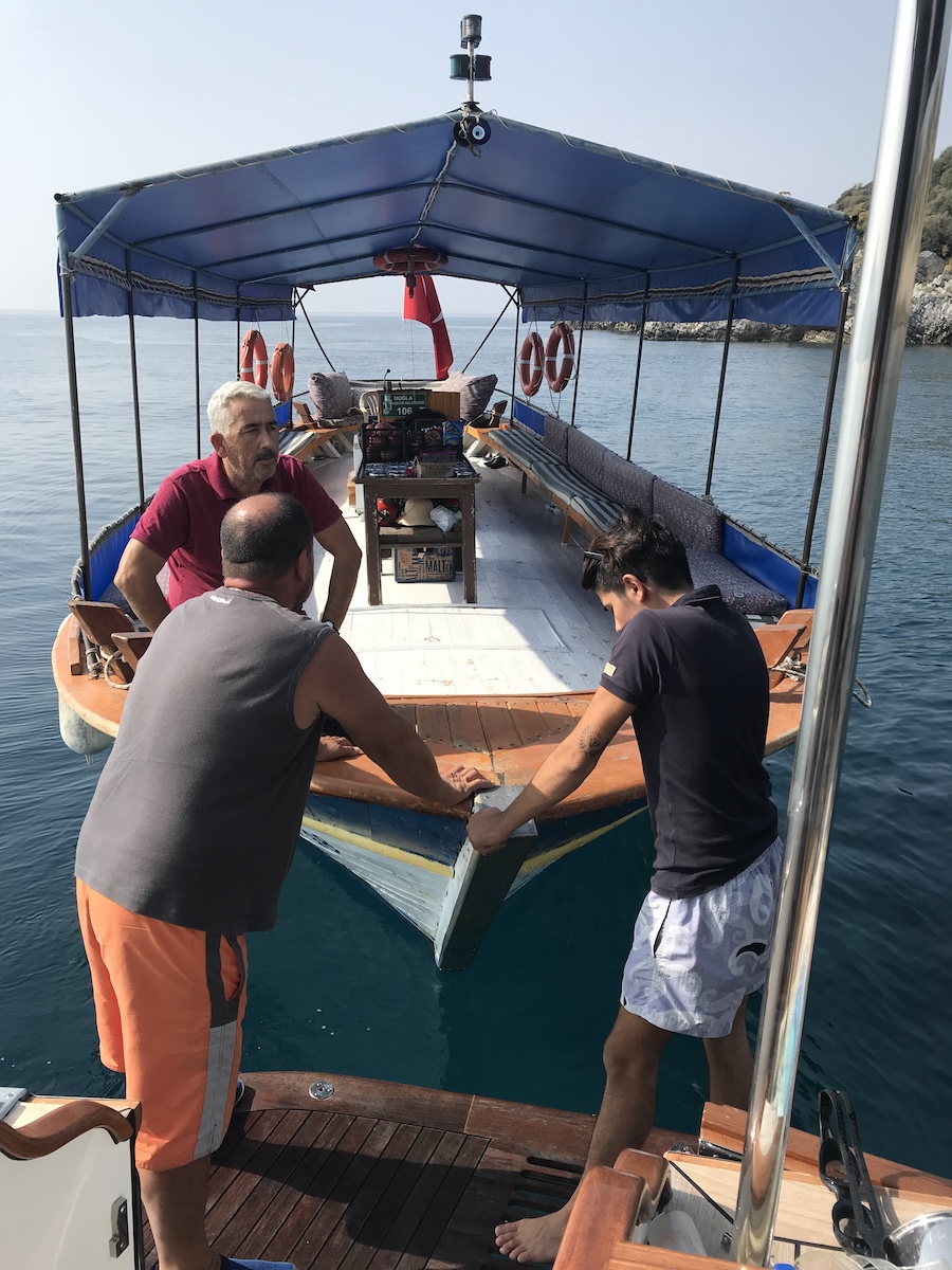Crew choosing a boat and captain for a cruise around Dalyan, Tüukiye