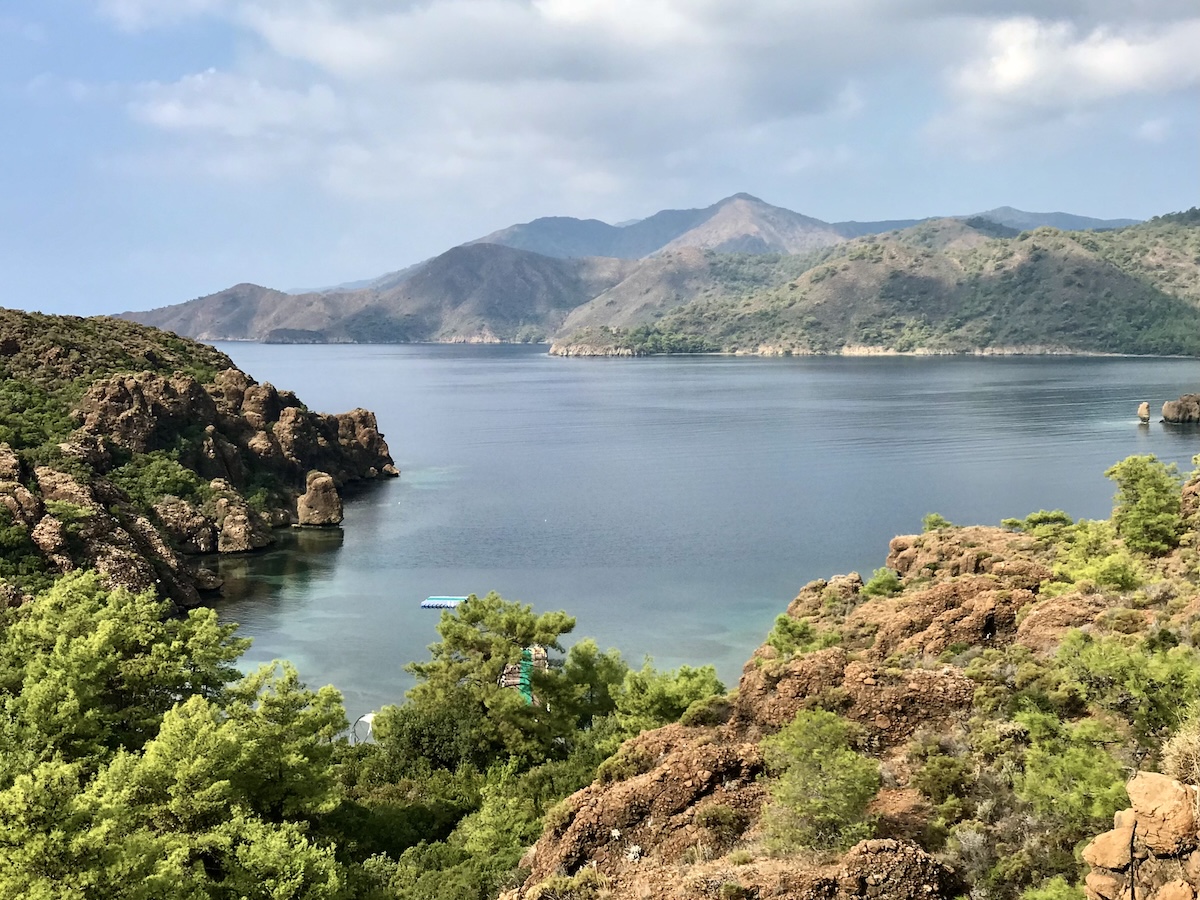 Colorful orange and green foliage on mountains surrounding the sea