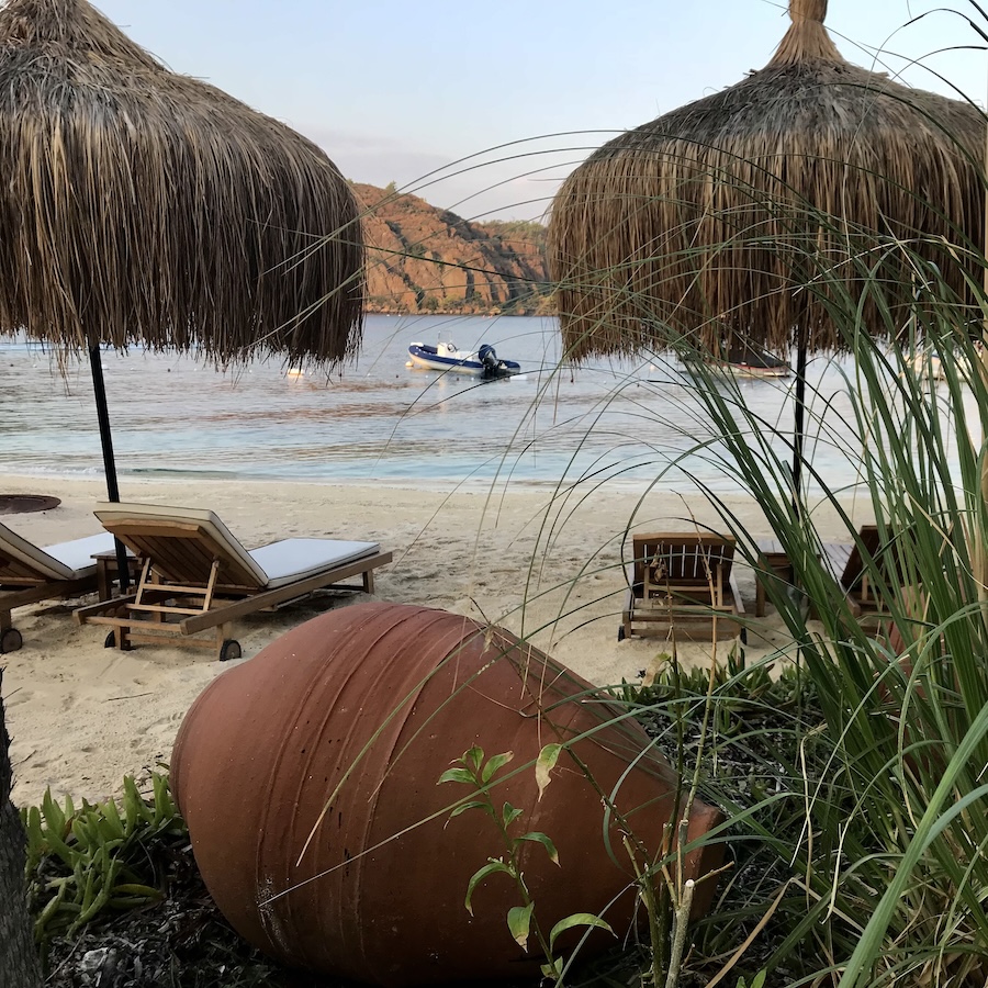 View between lounge chairs and grass umbrellas of the ocean