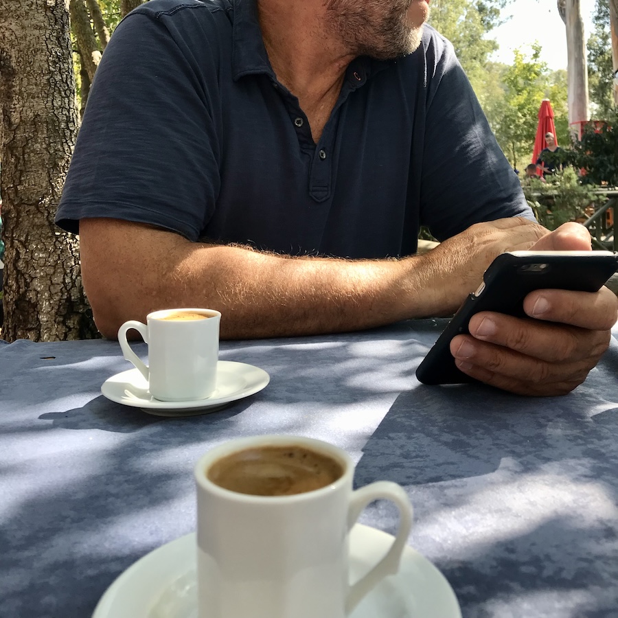 Two Turkish coffees on a table with a man sitting