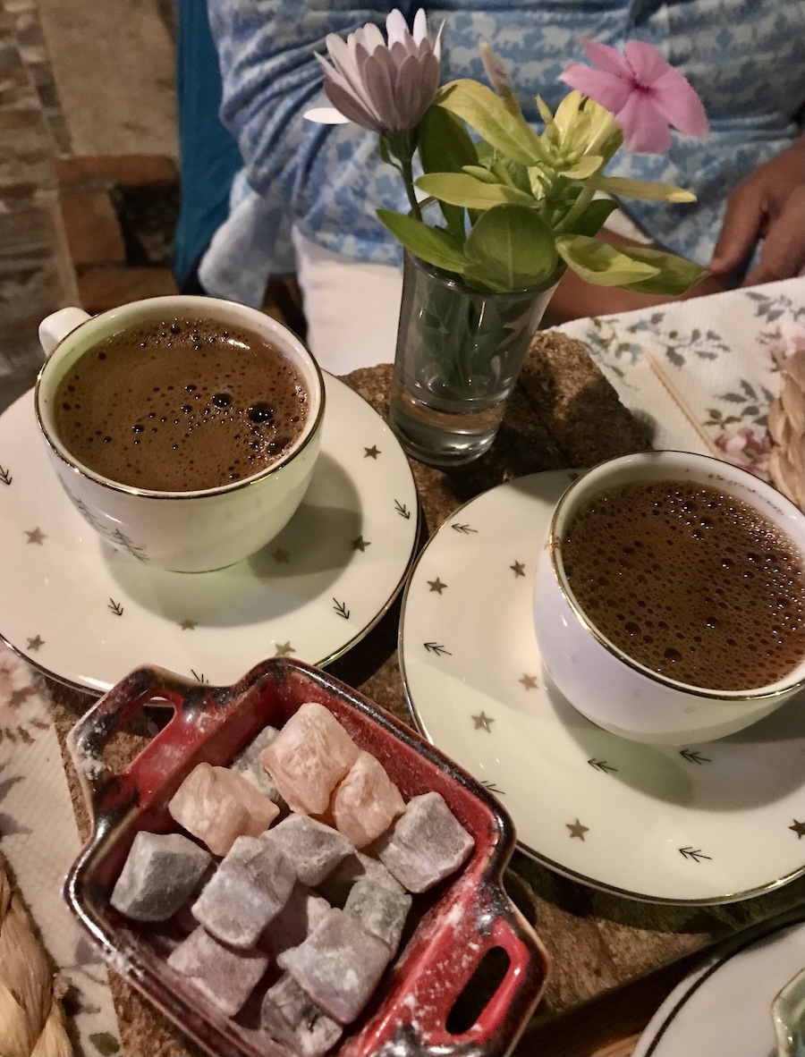 Two Turkish coffees and a colorful plate of gelatenous Turkish delight treats