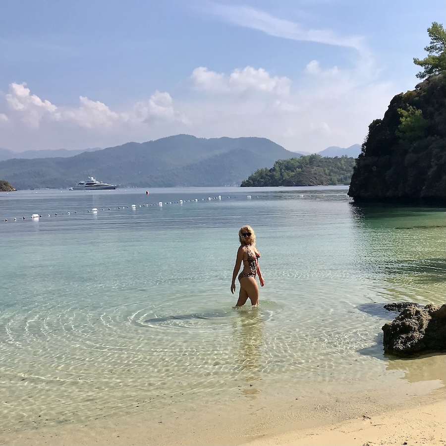 women posing in crystal ocean waters of D Maris Bay Türkiye
